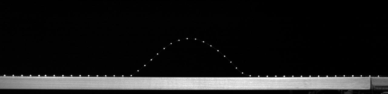 bead chain arch, appearing as white dots on a black background