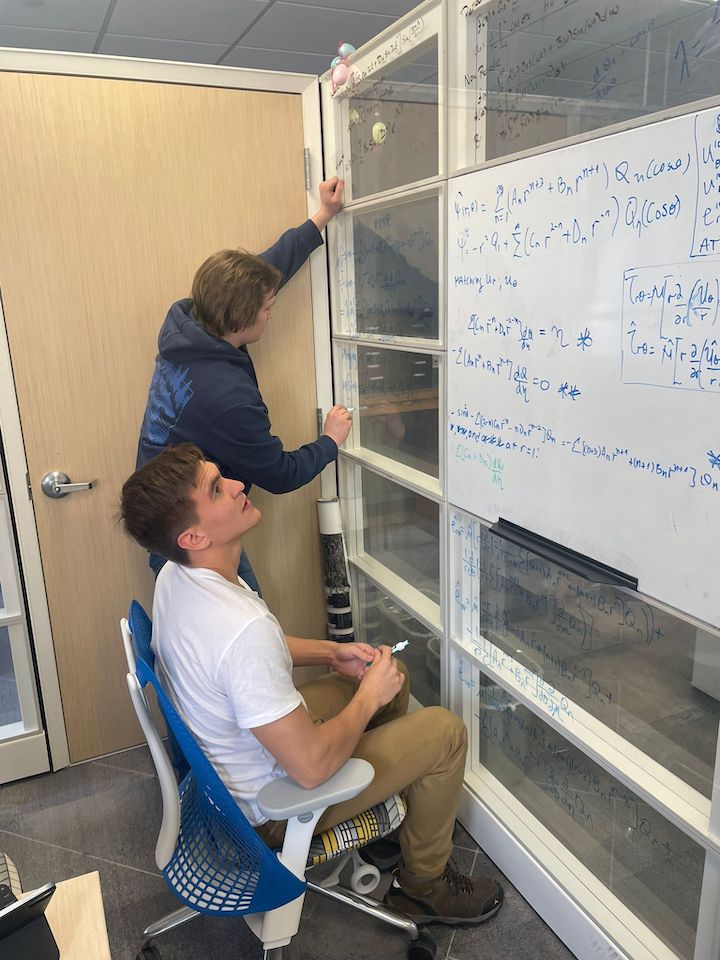 photograph of S Hutton and D Gimeno writing on a whiteboard